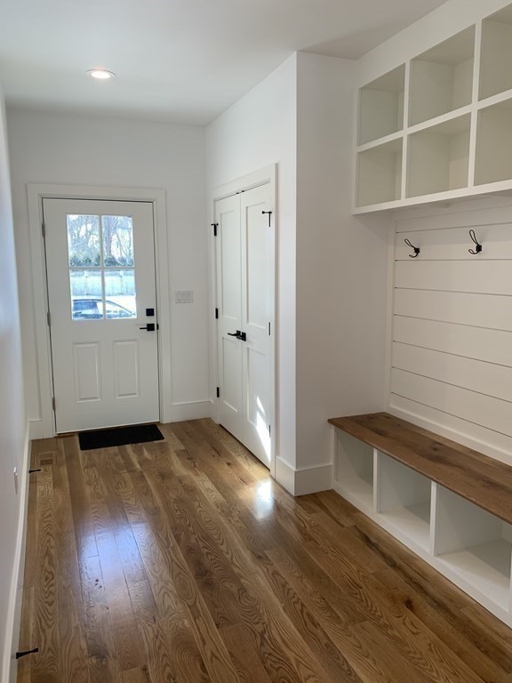 7 Sharon Avenue, Unit 7 Newton, MA 02466 - Photo 17 of 28 a view of an empty room with a window and wooden floor