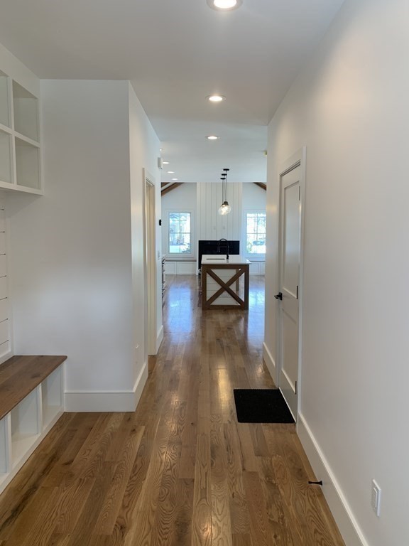 7 Sharon Avenue, Unit 7 Newton, MA 02466 - Photo 18 of 28 a view of a hallway with wooden floor and furniture