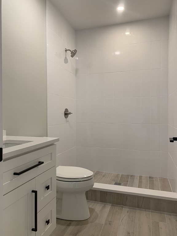 7 Sharon Avenue, Unit 7 Newton, MA 02466 - Photo 23 of 28 a bathroom with a white toilet and a shower