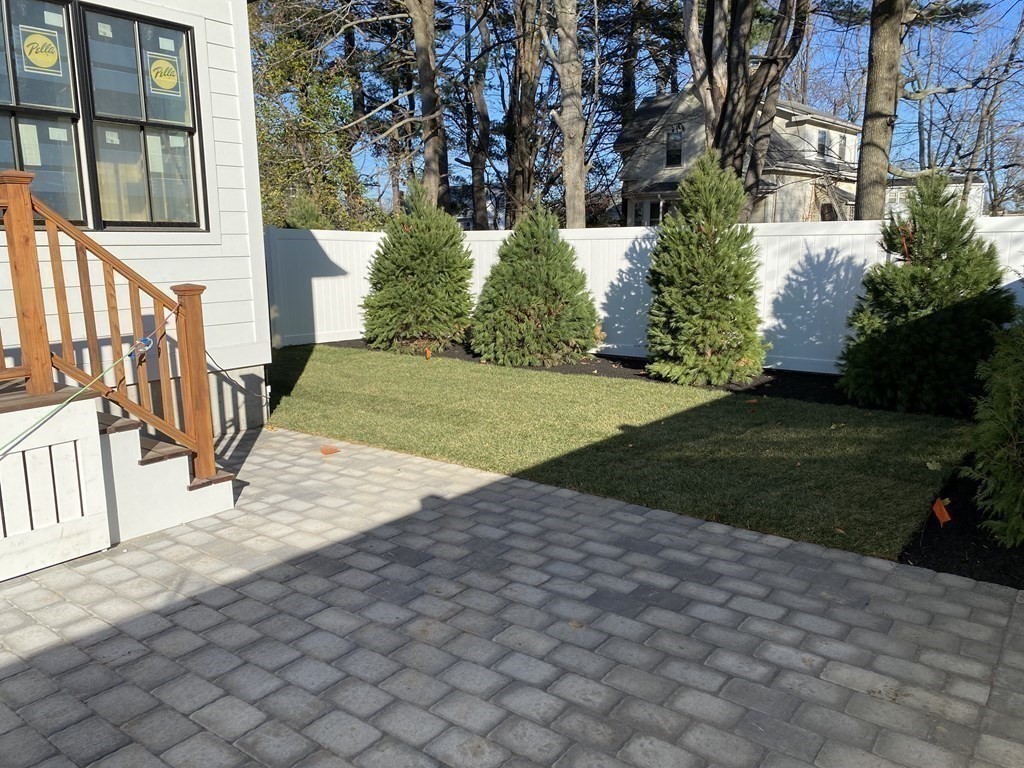 7 Sharon Avenue, Unit 7 Newton, MA 02466 - Photo 26 of 28 a view of a yard and front door