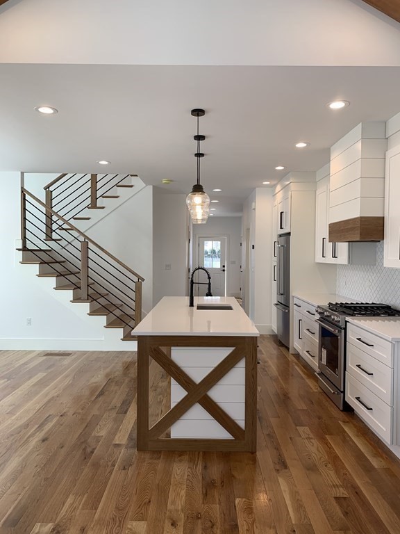 7 Sharon Avenue, Unit 7 Newton, MA 02466 - Photo 3 of 28 a view of a kitchen with furniture and wooden floor