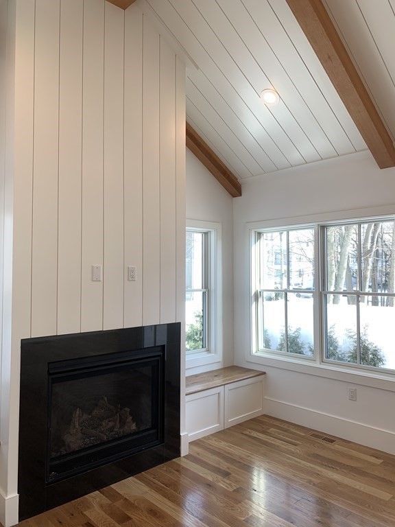7 Sharon Avenue, Unit 7 Newton, MA 02466 - Photo 5 of 28 a living room with furniture and a fireplace