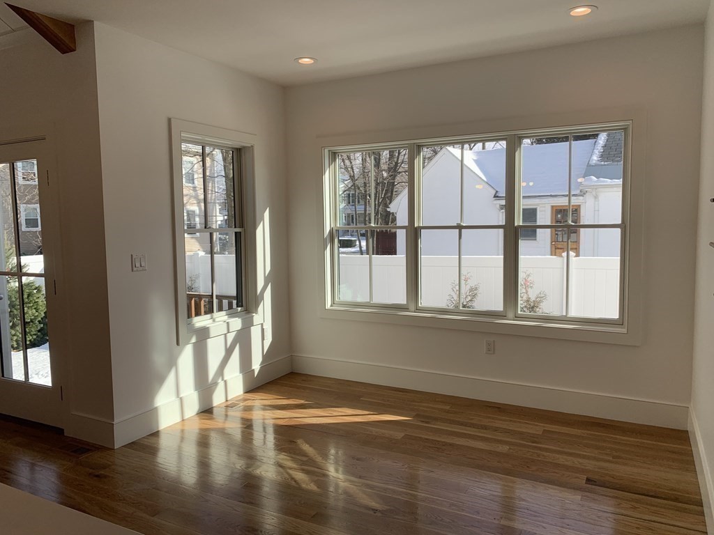 7 Sharon Avenue, Unit 7 Newton, MA 02466 - Photo 6 of 28 a view of empty room with wooden floor and fan