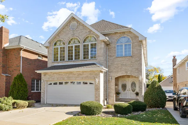 a view of a white house with a yard and potted plants