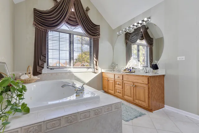 a bathroom with a sink a bathtub and a mirror