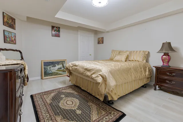 a bedroom with a bed and a dresser