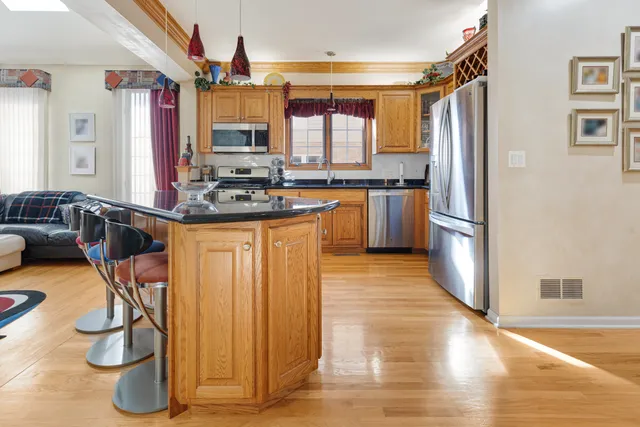 a kitchen with stainless steel appliances granite countertop a refrigerator and a stove