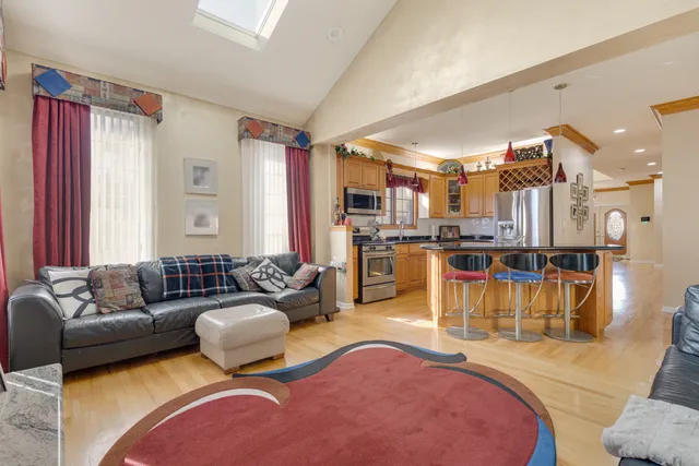 a living room with furniture and a view of kitchen