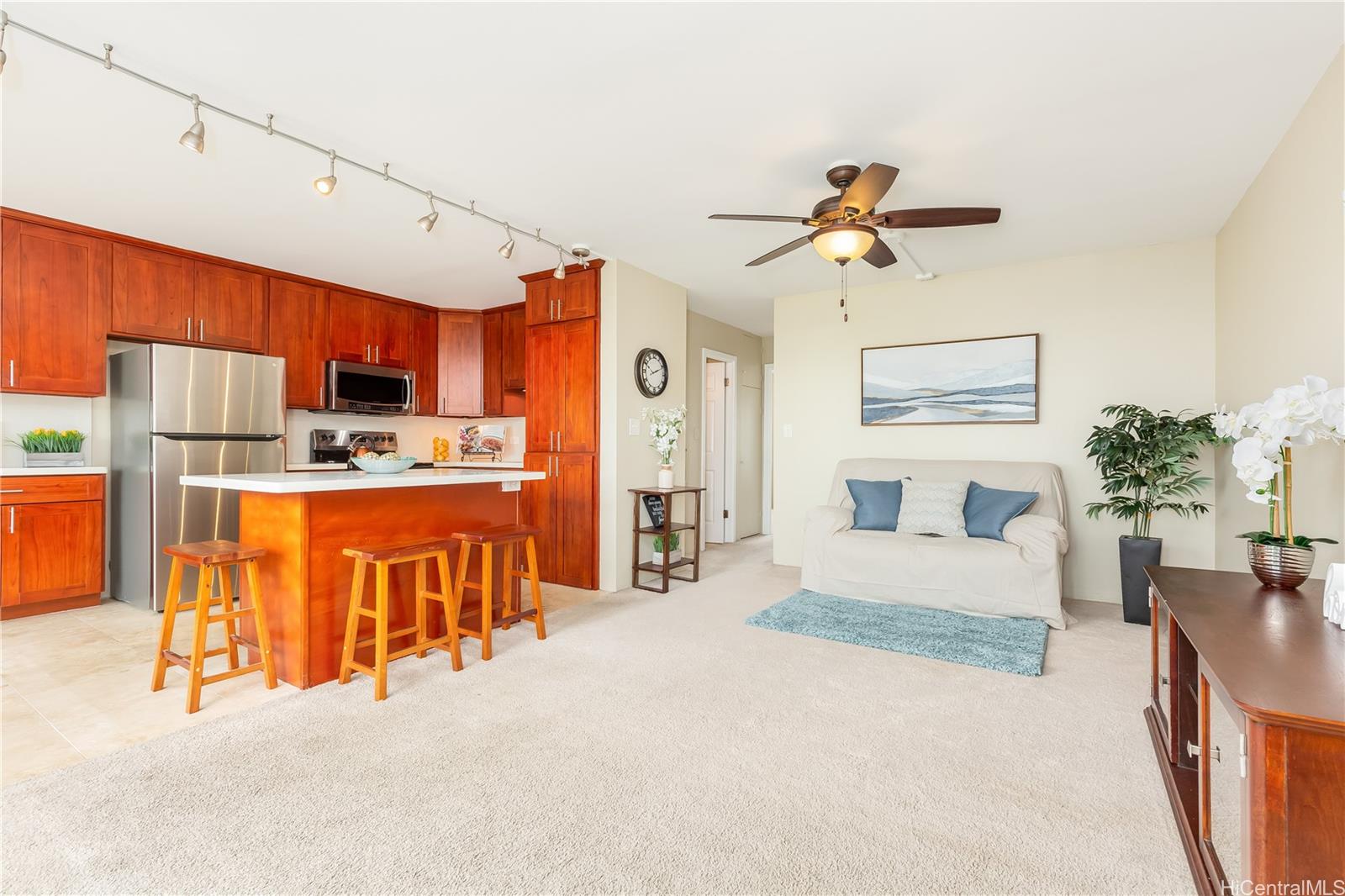 45-535 Luluku Road, Unit M5 Kaneohe, HI 96744 - Photo 1 of 1 a living room with stainless steel appliances kitchen island granite countertop furniture and a kitchen view