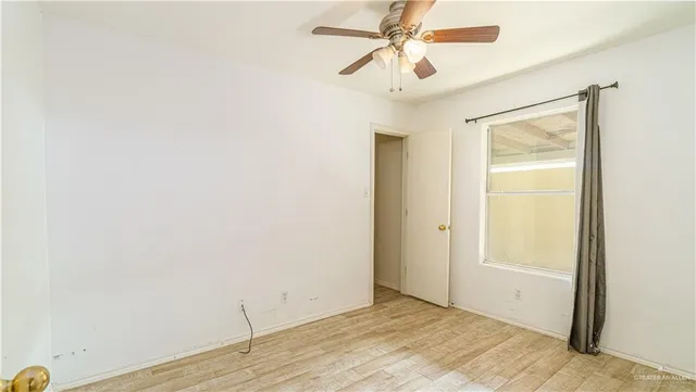 a view of a room with wooden floor and closet area