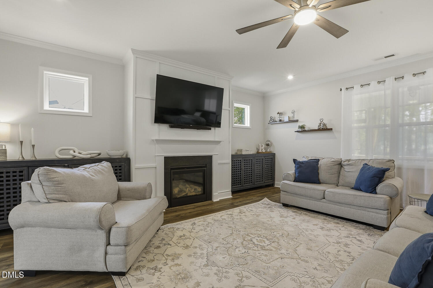 801 Oak Rose Lane Rolesville, NC 27571 - Photo 13 of 70 a living room with furniture a flat screen tv and a fireplace
