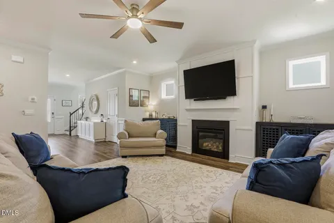 a kitchen with stainless steel appliances granite countertop a table chairs sink refrigerator and cabinets