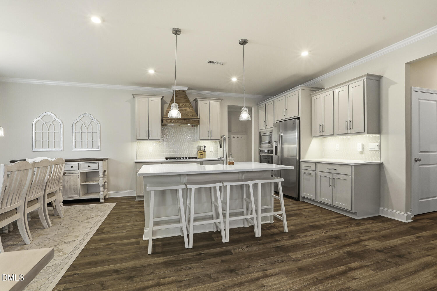 801 Oak Rose Lane Rolesville, NC 27571 - Photo 17 of 70 a kitchen with stainless steel appliances granite countertop a table chairs sink refrigerator and cabinets