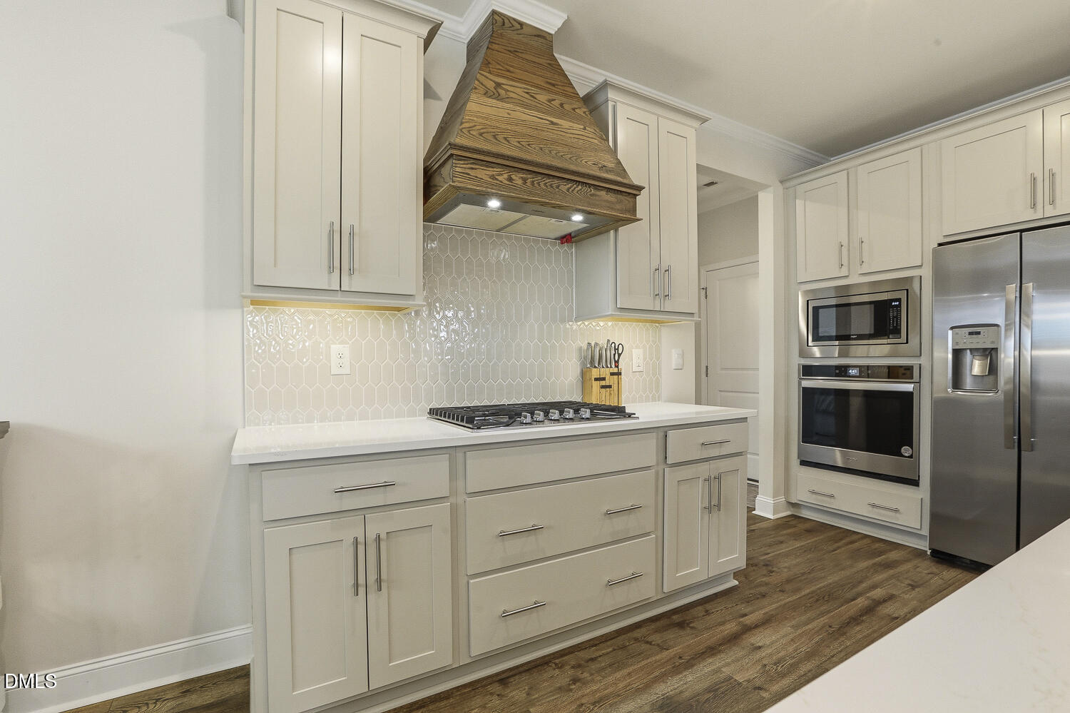 801 Oak Rose Lane Rolesville, NC 27571 - Photo 23 of 70 a kitchen with white cabinets and stainless steel appliances