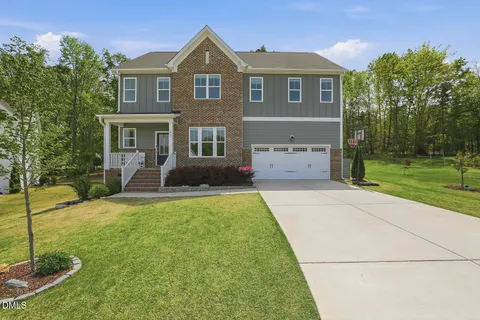 a front view of a house with a yard