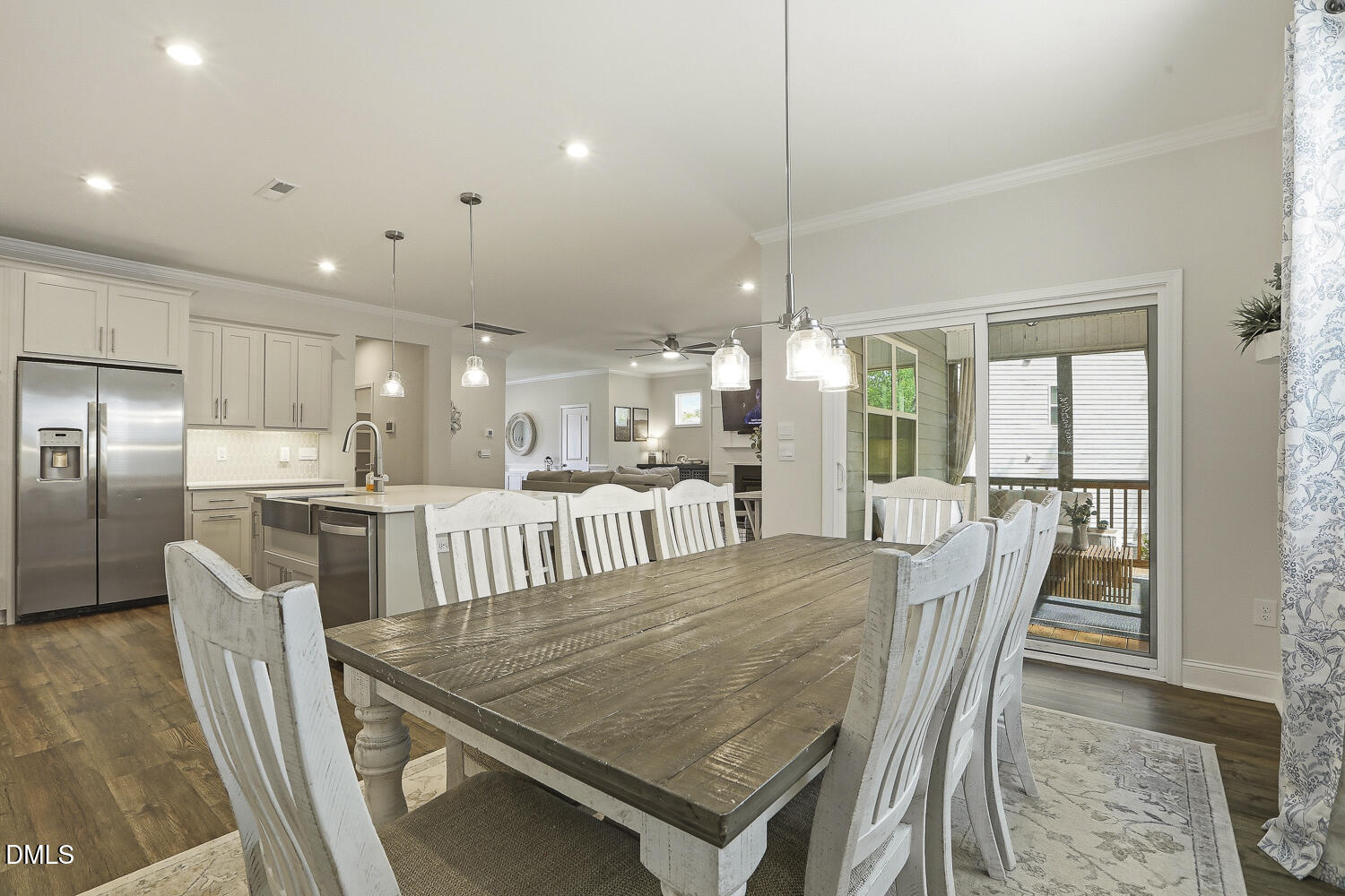 801 Oak Rose Lane Rolesville, NC 27571 - Photo 30 of 70 a dining room with furniture a chandelier and wooden floor