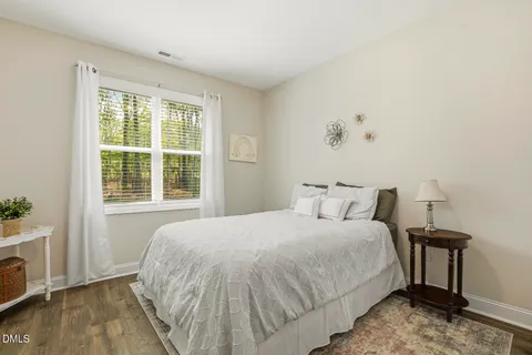 a spacious bathroom with a double vanity sink a mirror and a shower