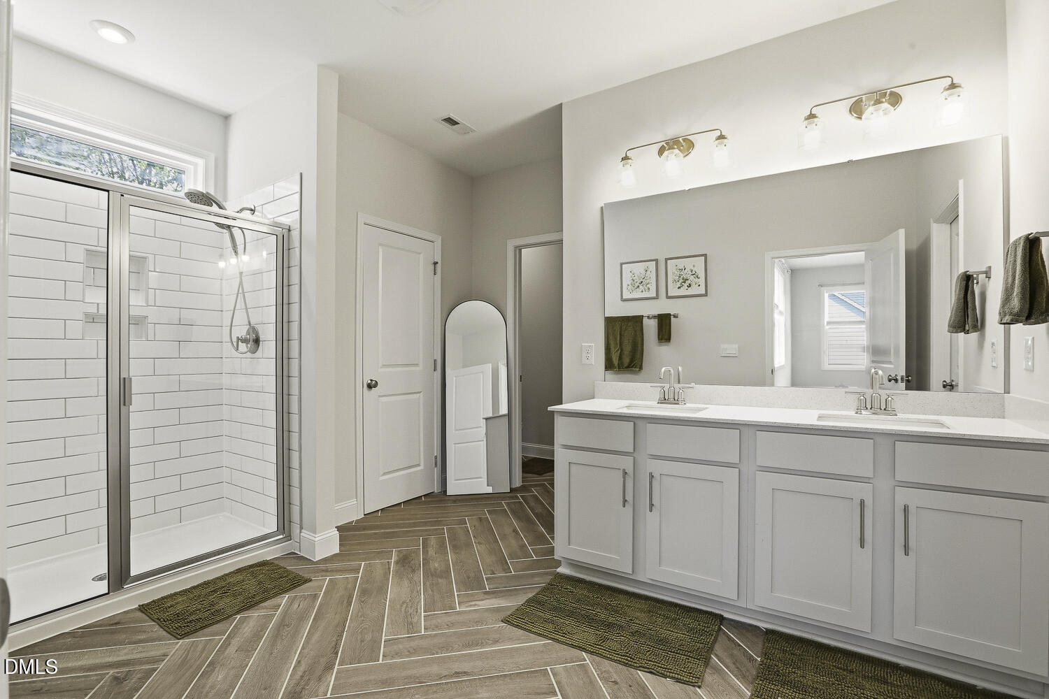 801 Oak Rose Lane Rolesville, NC 27571 - Photo 41 of 70 a spacious bathroom with a double vanity sink a mirror and a shower