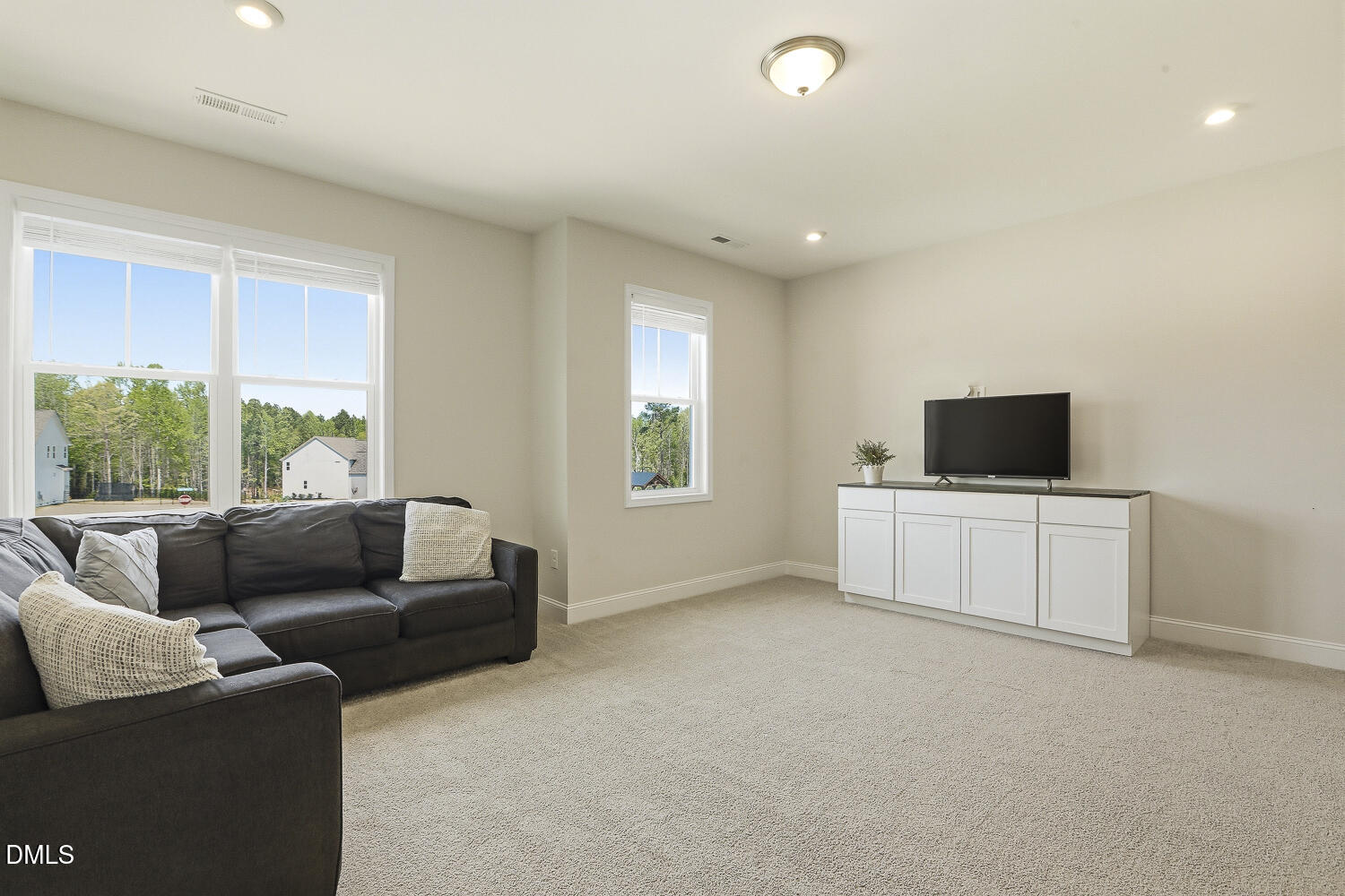 801 Oak Rose Lane Rolesville, NC 27571 - Photo 52 of 70 a living room with furniture and a flat screen tv