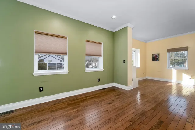 a large kitchen with cabinets table and chairs