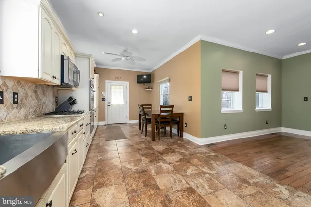 a kitchen with white cabinets and stainless steel appliances