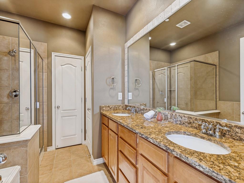 15741 Seabolt Place, Unit 28 Addison, TX 75001 - Photo 15 of 37 Bathroom featuring double vanity, light tile patterned flooring, a stall shower, and a garden tub
