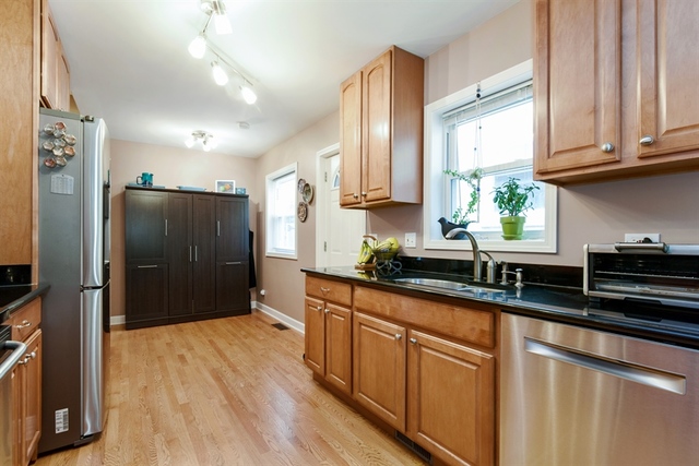 1425 Brummel Street Evanston, IL 60202 - Photo 6 of 24 a kitchen with stainless steel appliances granite countertop a refrigerator a sink dishwasher a stove and white countertops with wooden floor