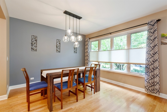 1425 Brummel Street Evanston, IL 60202 - Photo 9 of 24 a view of a dining room with furniture a chandelier and wooden floor