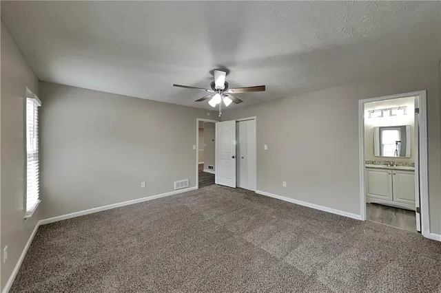 a view of a livingroom with a ceiling fan and window