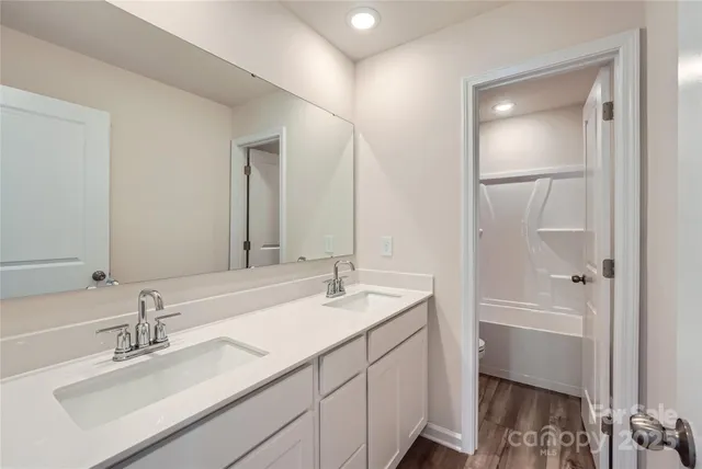 a bathroom with a sink a vanity and a mirror