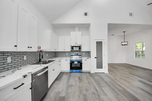 a kitchen with granite countertop a stove top oven and sink
