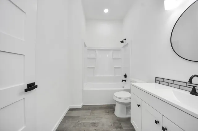 a bathroom with a toilet a sink and a mirror