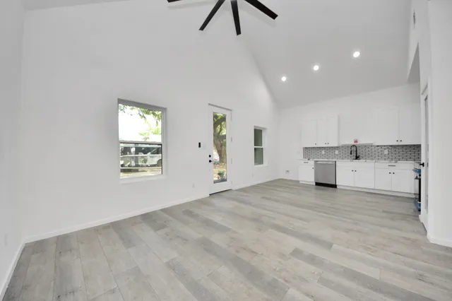 a view of a kitchen with a sink hardwood floor and a window
