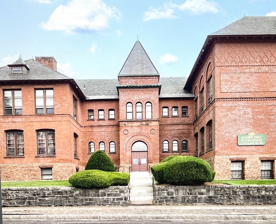 a front view of a residential apartment building with a yard
