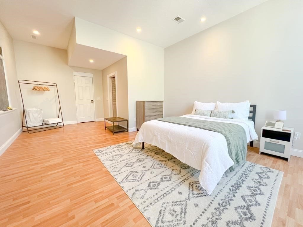 31 Elizabeth Street, Unit 202 Worcester, MA 01605 - Photo 12 of 12 a bedroom with a large bed and wooden floor