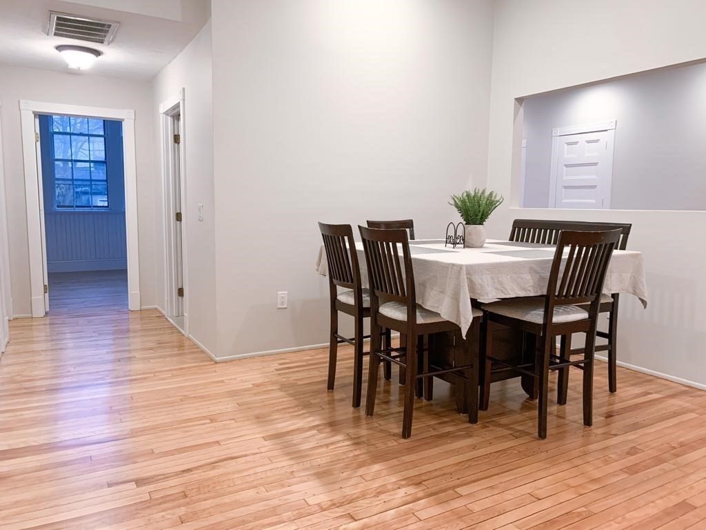 31 Elizabeth Street, Unit 202 Worcester, MA 01605 - Photo 3 of 12 a view of a dining room with furniture and wooden floor