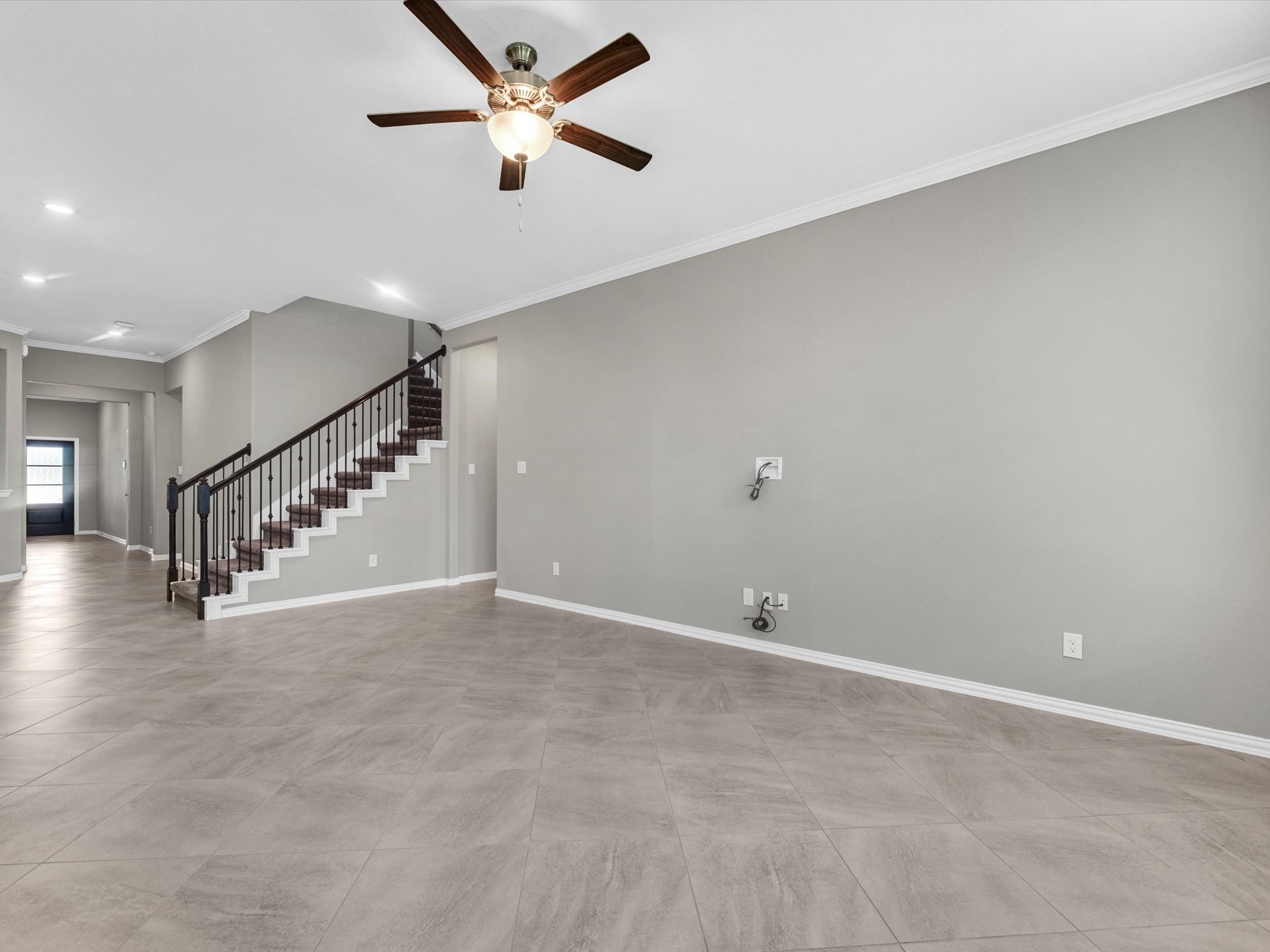 31120 Aspen Gate Trail Spring, TX 77386 - Photo 8 of 33 a view of an empty room with stairs and a ceiling fan