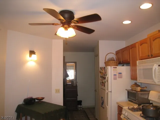 a kitchen with stainless steel appliances granite countertop cabinets and a refrigerator