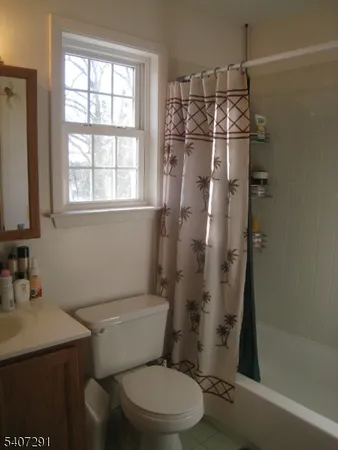 a bathroom with a toilet a sink and shower