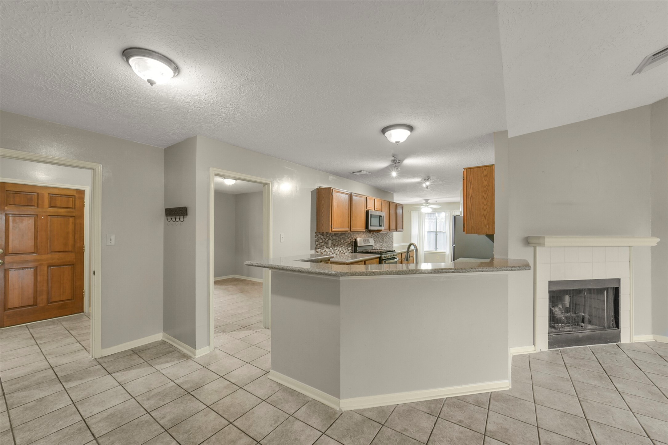 5539 Rivertree Lane Spring, TX 77379 - Photo 11 of 25 a kitchen with stainless steel appliances a sink and a refrigerator