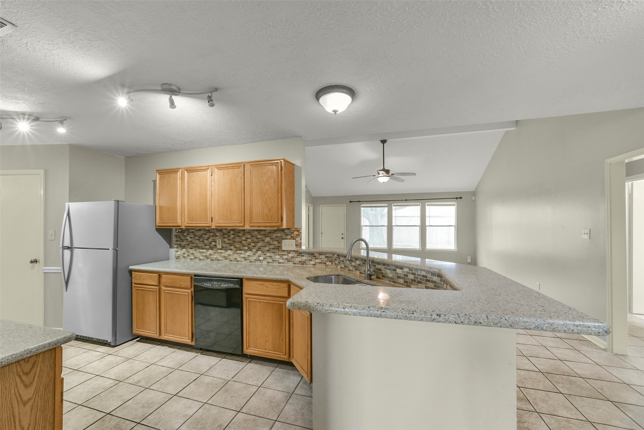 5539 Rivertree Lane Spring, TX 77379 - Photo 12 of 25 a kitchen with stainless steel appliances granite countertop a sink and a stove