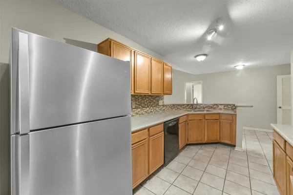 a kitchen with a refrigerator and a sink