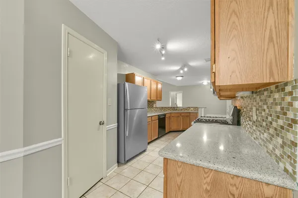 a kitchen with refrigerator and cabinets