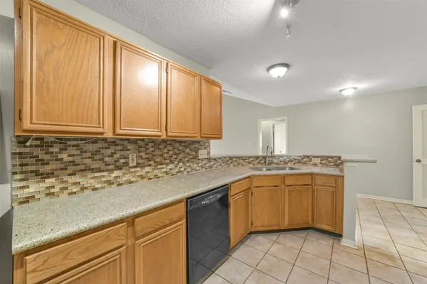 a kitchen with stainless steel appliances granite countertop a sink and cabinets
