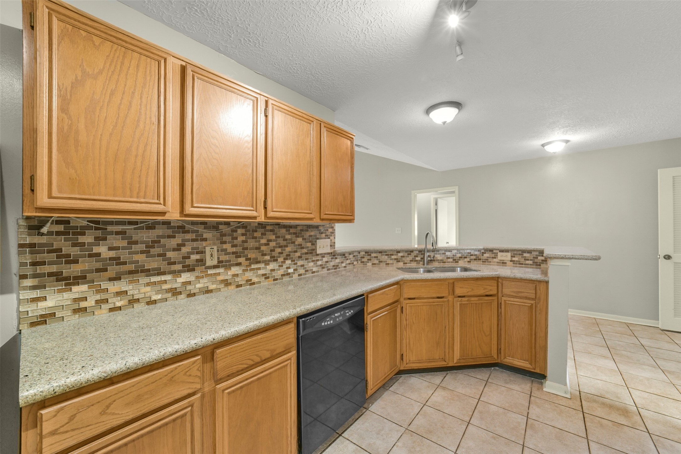 5539 Rivertree Lane Spring, TX 77379 - Photo 16 of 25 a kitchen with stainless steel appliances granite countertop a sink and cabinets