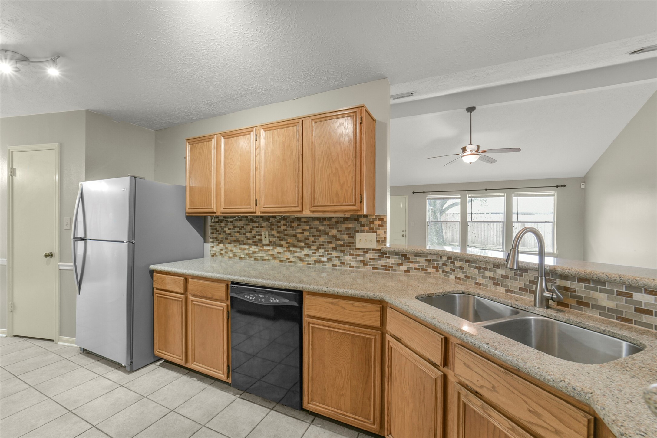 5539 Rivertree Lane Spring, TX 77379 - Photo 18 of 25 a kitchen with a sink cabinets and window