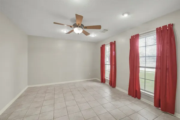 a view of an empty room with a fan
