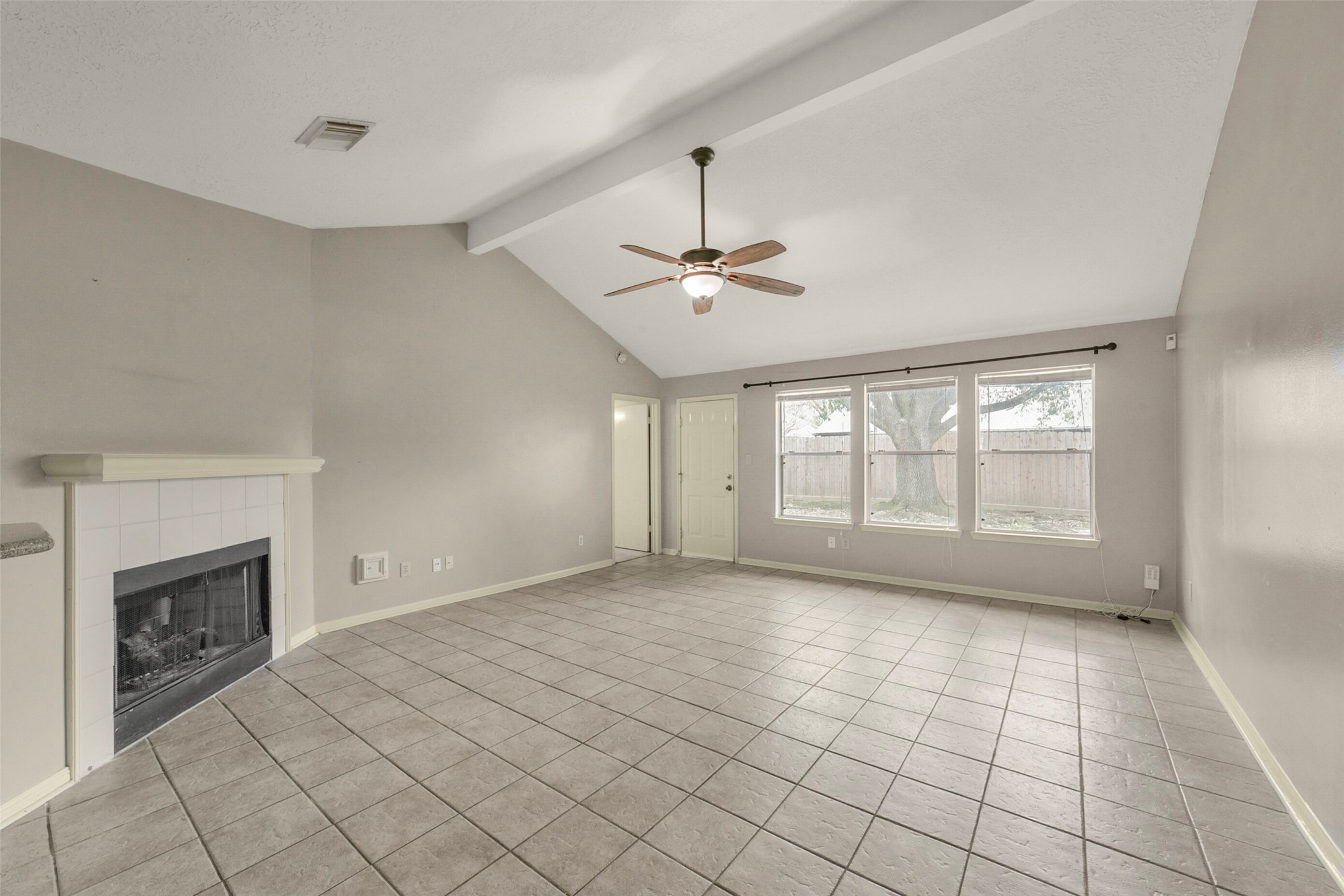 5539 Rivertree Lane Spring, TX 77379 - Photo 8 of 25 a view of an empty room with a fireplace and a window