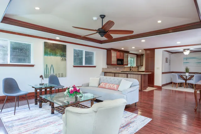 a living room with furniture and kitchen view