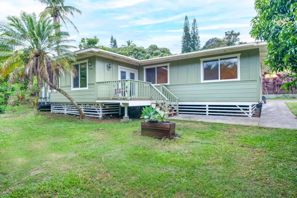 a front view of house with yard and outdoor seating
